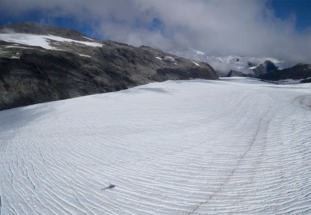 Shadow of helicopter flying over glacier Mount Aspiring National Park West Coast South Island New Zealand Canvas Art - Panoramic Images (18 x 24)