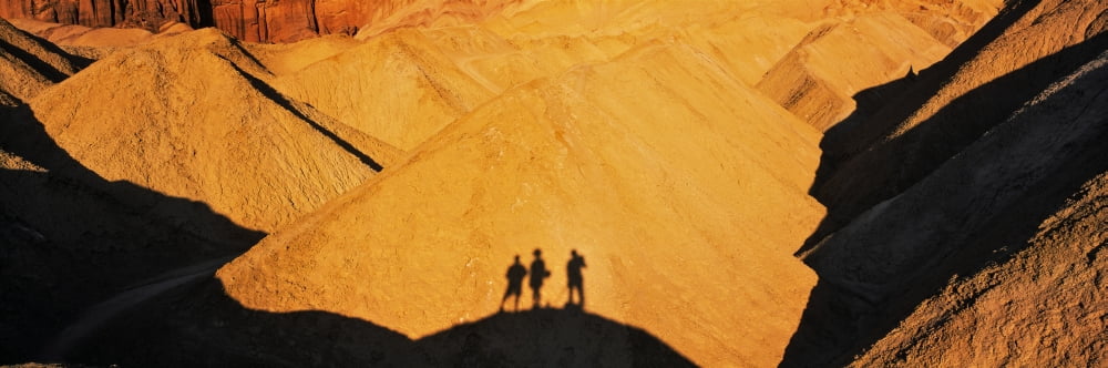 Shadow of hikers on hill Manly Beacon Golden Canyon Trail Death Valley National Park California USA Canvas Art - Panoramic Images (12 x 36)