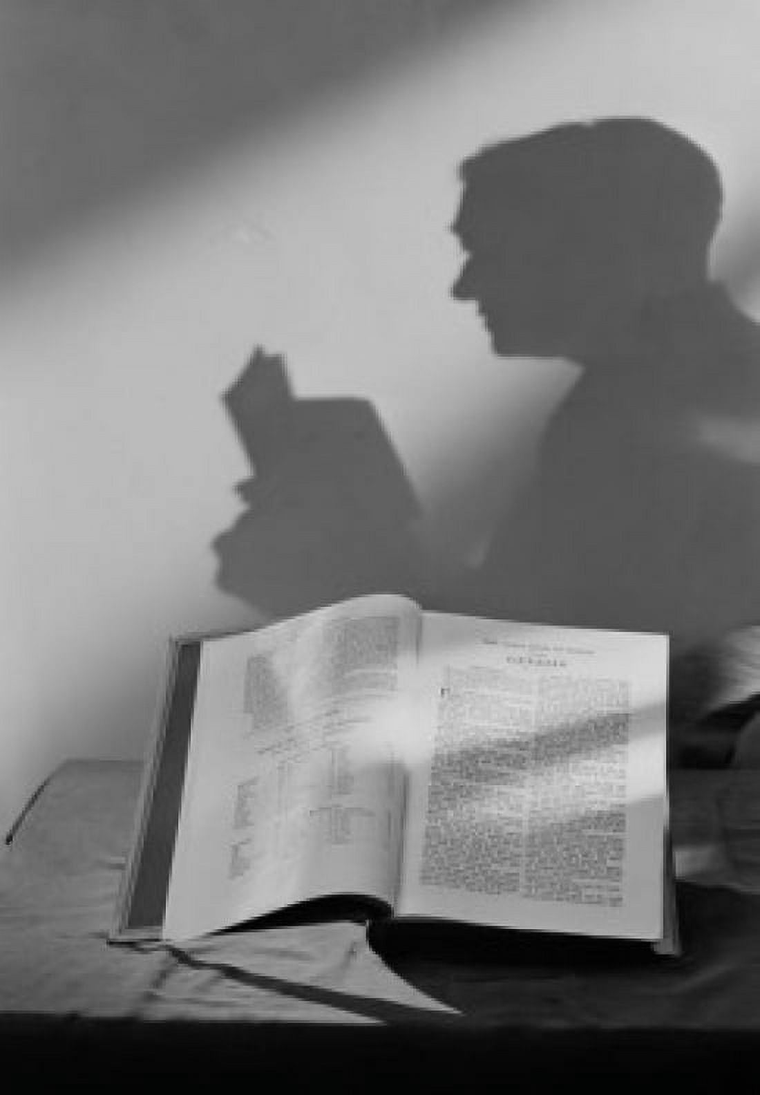 Shadow of man reading open bible Canvas Art - (18 x 24)