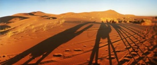 Shadows of camel riders in the desert at sunset Sahara Desert Morocco Canvas Art - Panoramic Images (30 x 13)