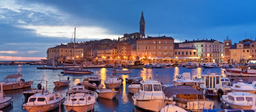 Ships and boats at the harbor and the old town with St Euphemias Basilica at dusk Rovinj Istria Croatia Canvas Art - Panoramic Images (36 x 12)