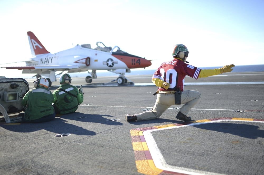 Shooter signals to the pilot of a T-45C Goshawk training aircraft Canvas Art - Stocktrek Images (35 x 23)