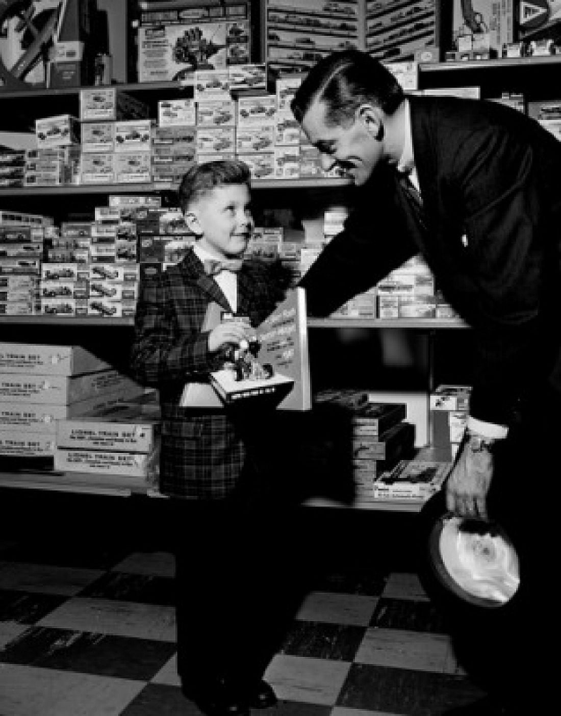 Shop assistant serving boy in toy shop Canvas Art - (18 x 24)