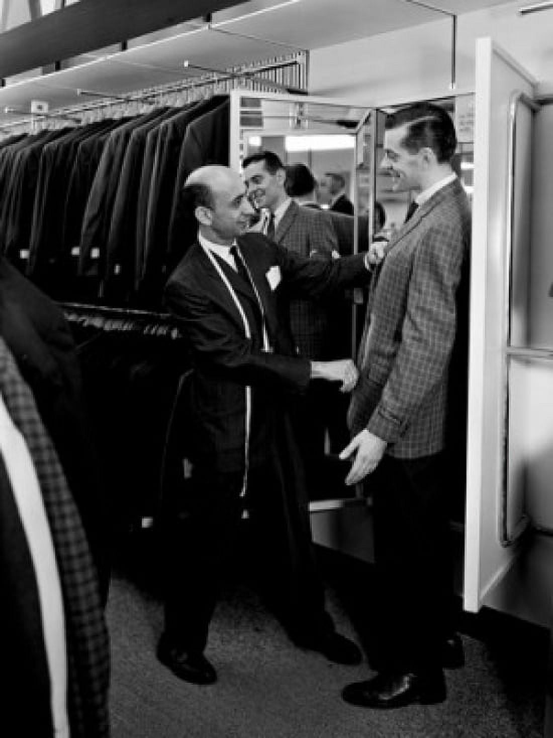 Shop assistant serving man trying on suit in shop Canvas Art - (18 x 24)