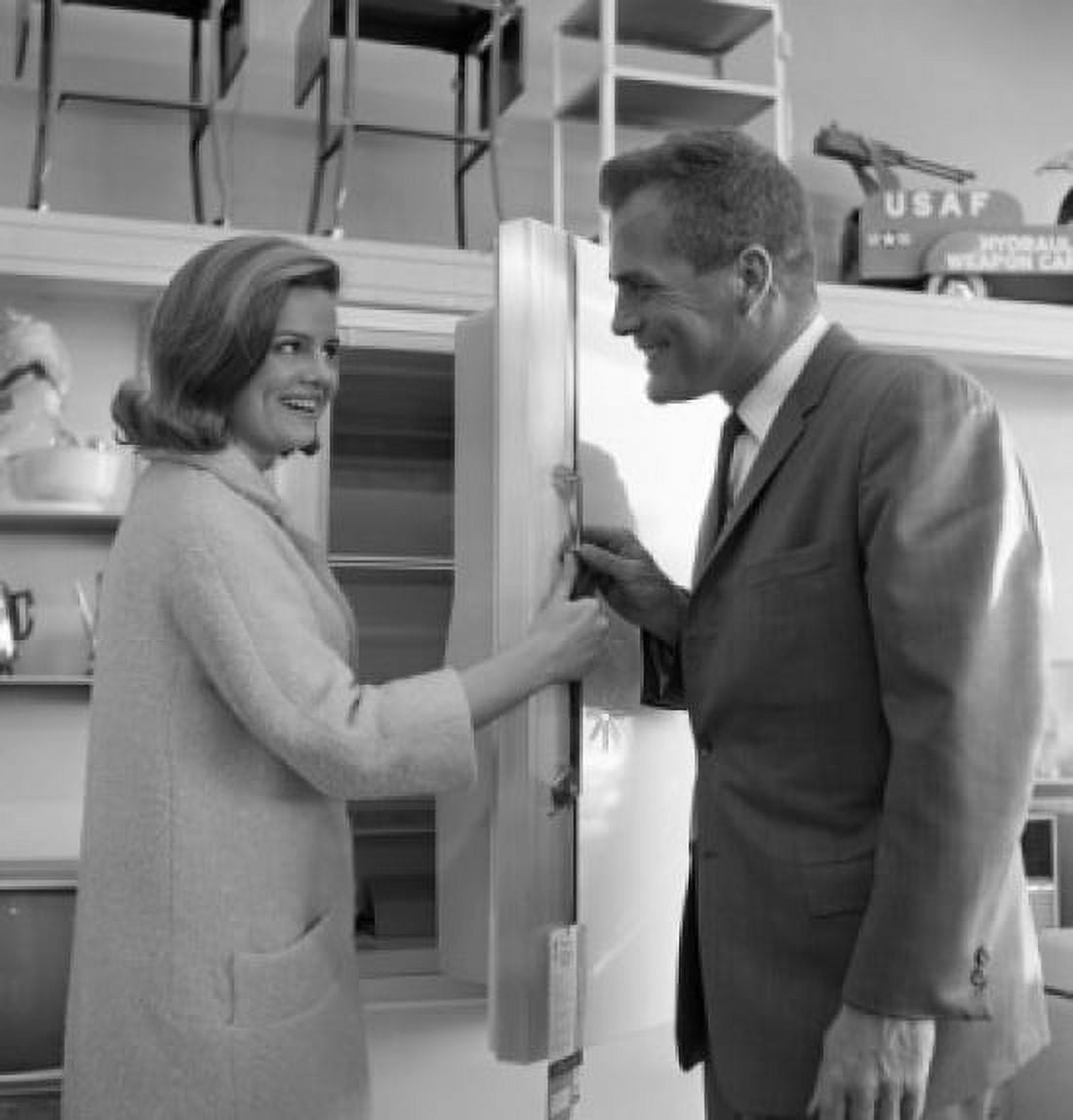 Shop assistant showing interior of fridge to woman Canvas Art - (18 x 24)