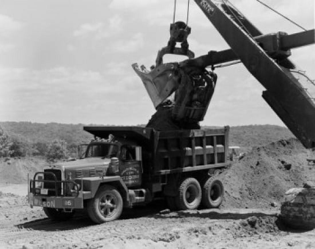 Shovel depositing earth into truck Canvas Art - (18 x 24)