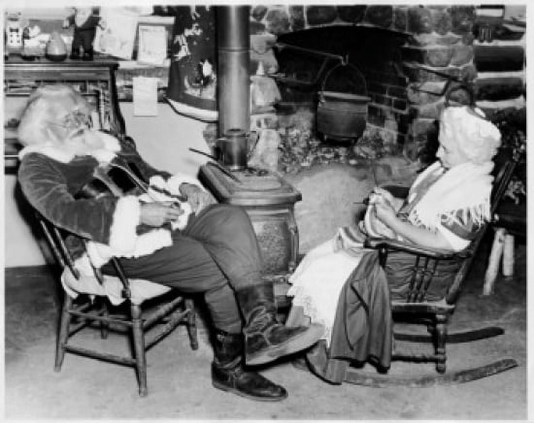 Side profile of Santa Claus sitting with a senior woman near a fireplace Canvas Art - (24 x 36)