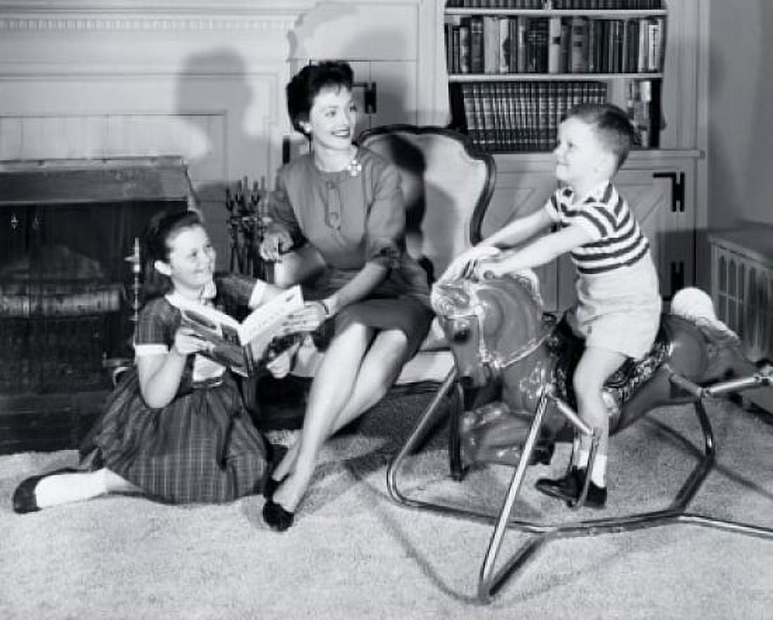 Side profile of a boy sitting on a rocking horse with his mother and sister sitting beside him Canvas Art - (18 x 24)