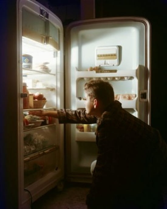 Side profile of a boy taking food from a refrigerator Canvas Art - (18 x 24)