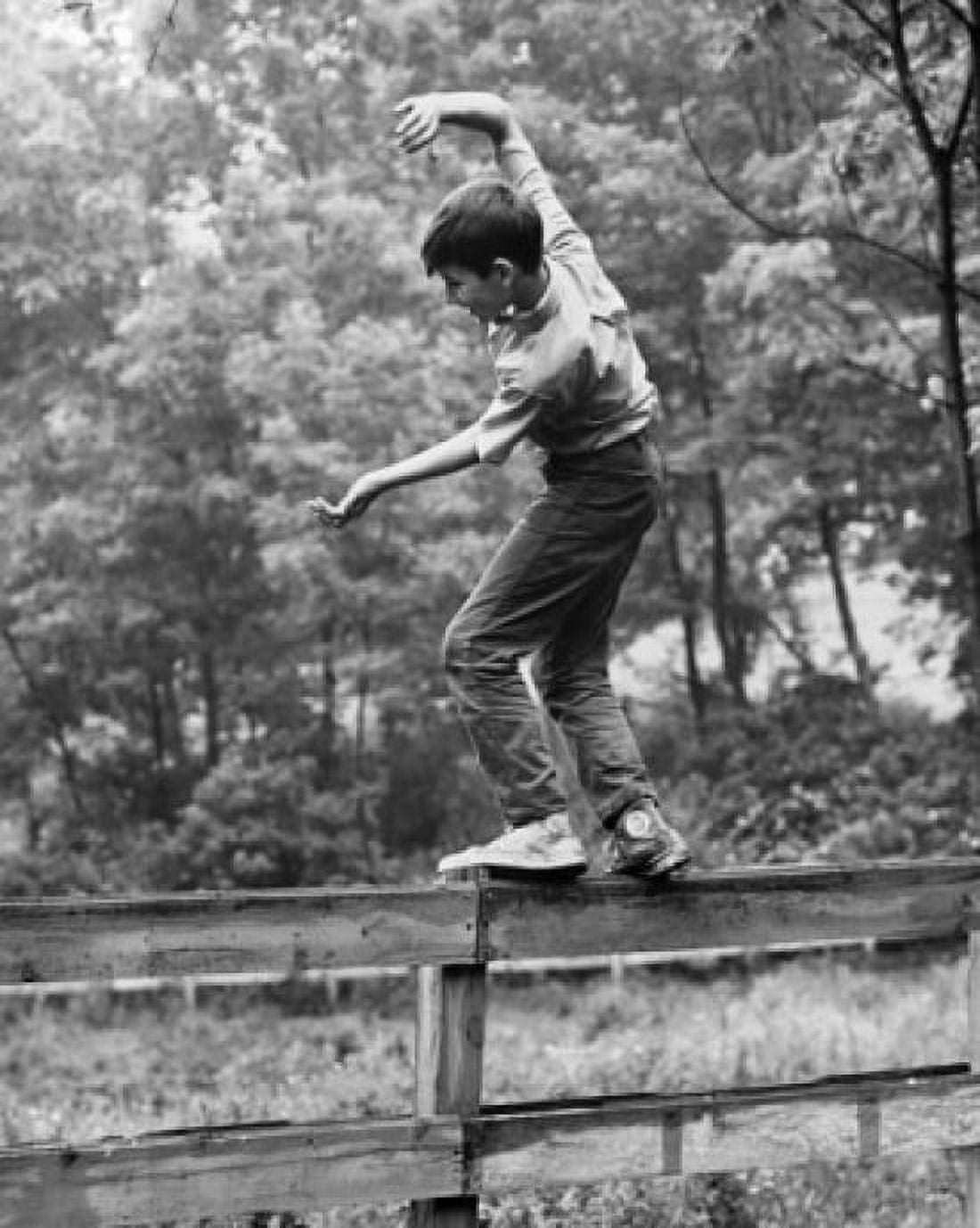 Side profile of a boy walking on a fence Canvas Art - (18 x 24)