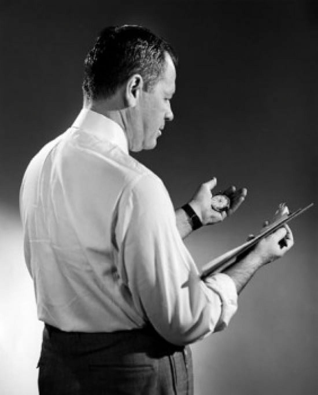 Side profile of a businessman holding a clipboard and a stopwatch Canvas Art - (18 x 24)