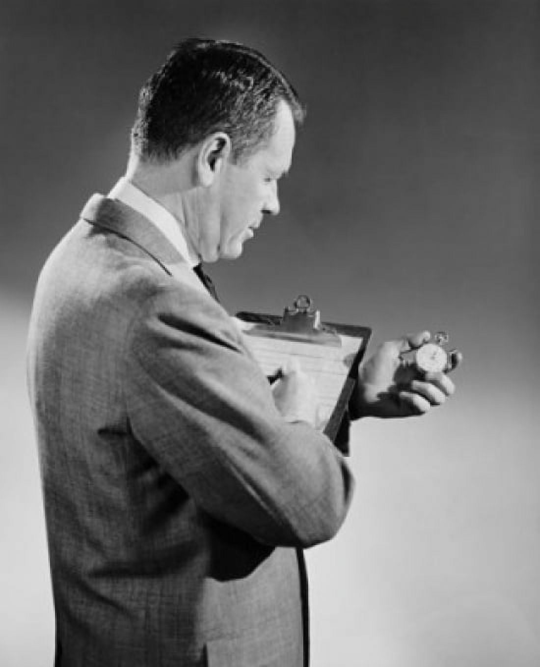 Side profile of a businessman holding a stopwatch and a clipboard Canvas Art - (18 x 24)