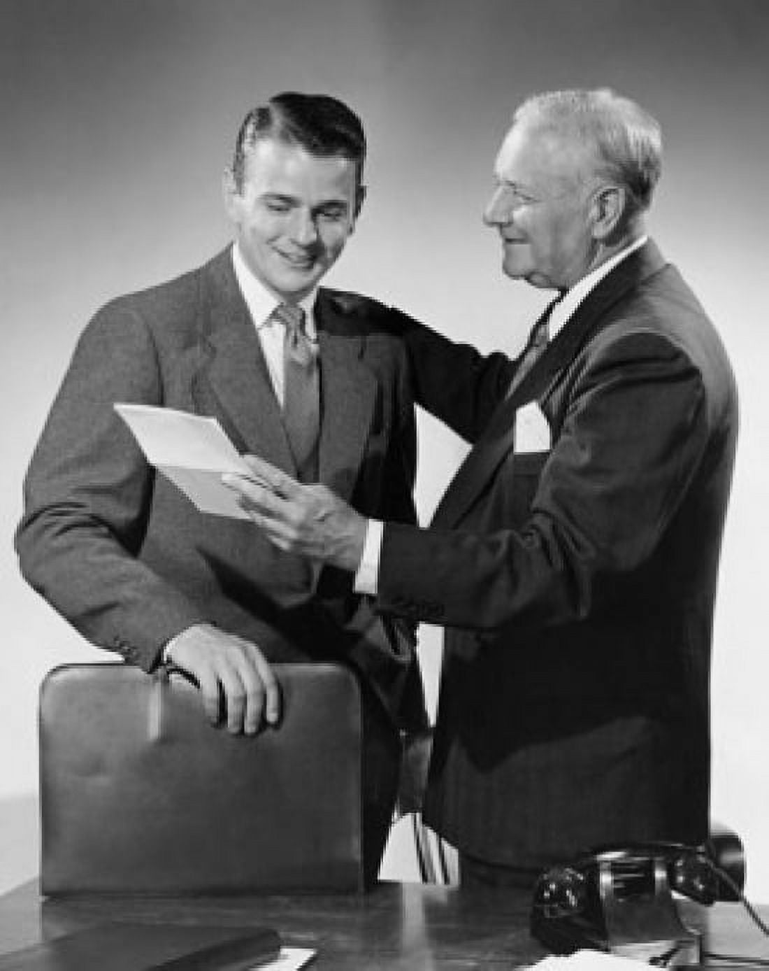 Side profile of a businessman showing a document to a businessman Canvas Art - (24 x 36)