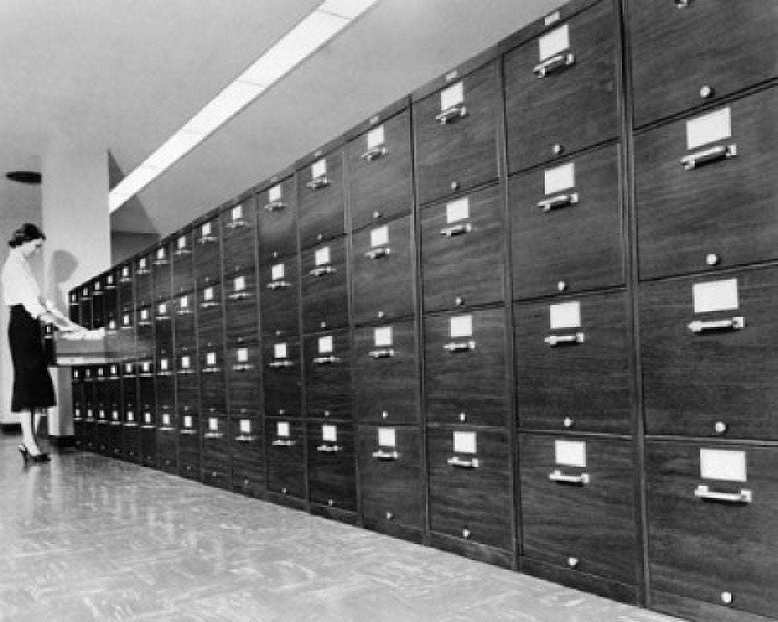 Side profile of a businesswoman searching for files in a filing cabinet Canvas Art - (18 x 24)