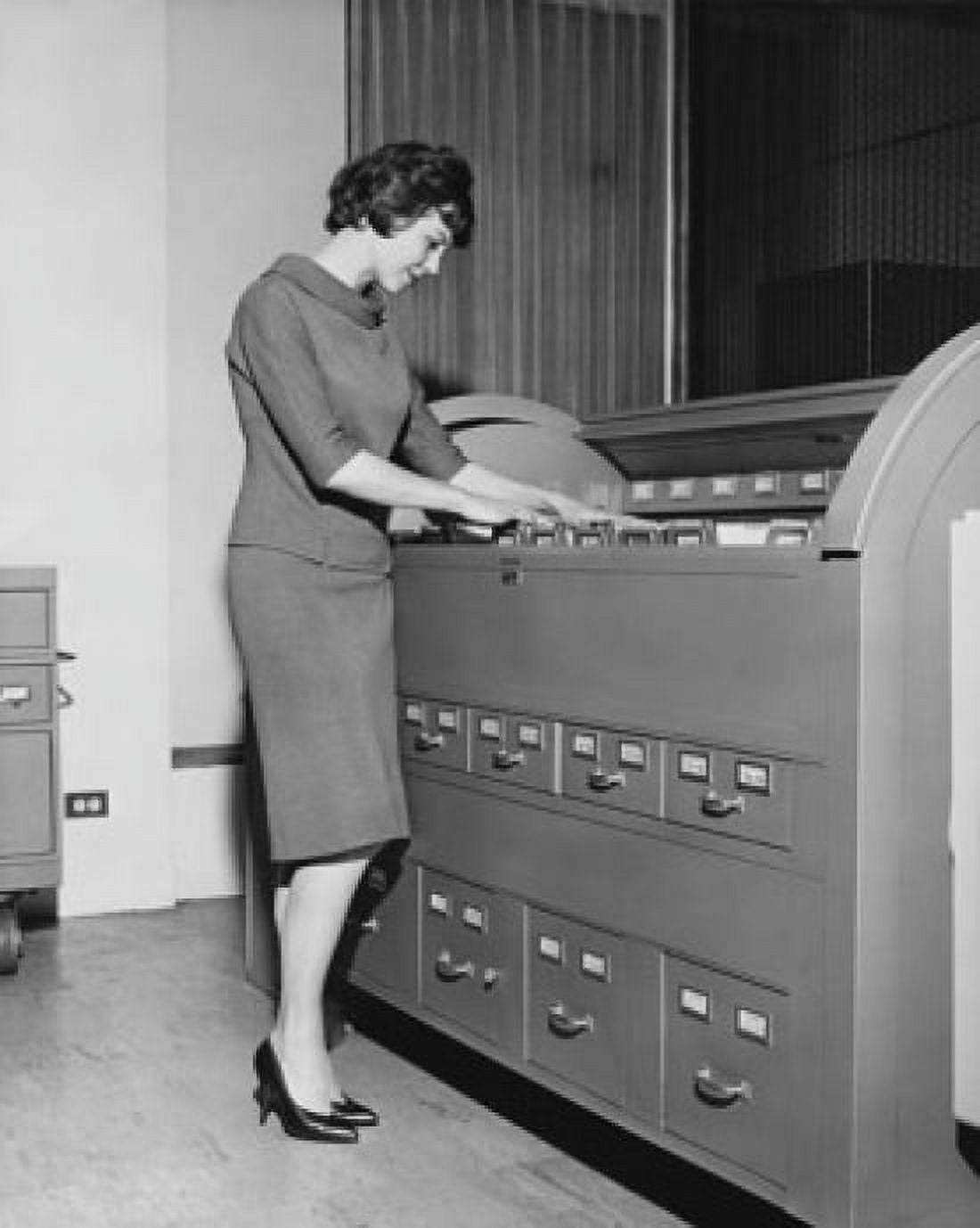 Side profile of a businesswoman searching for files in a filing cabinet Canvas Art - (24 x 36)
