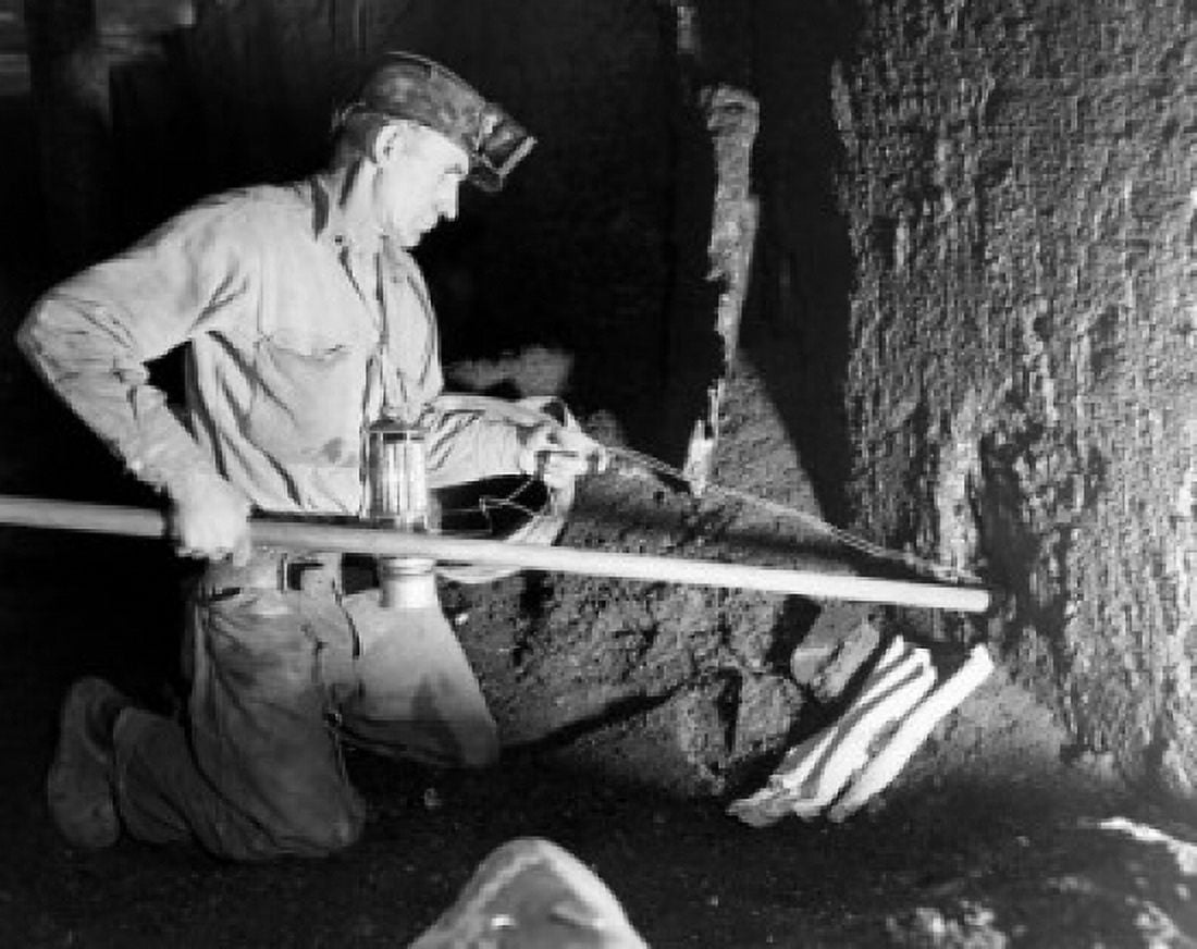 Side profile of a coal miner putting dynamite in to a hole Canvas Art - (24 x 36)