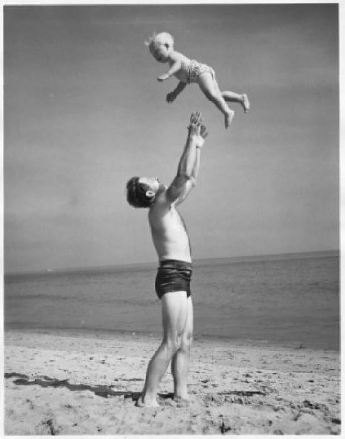 Side profile of a father tossing his son into the air at the beach Canvas Art - (24 x 36)
