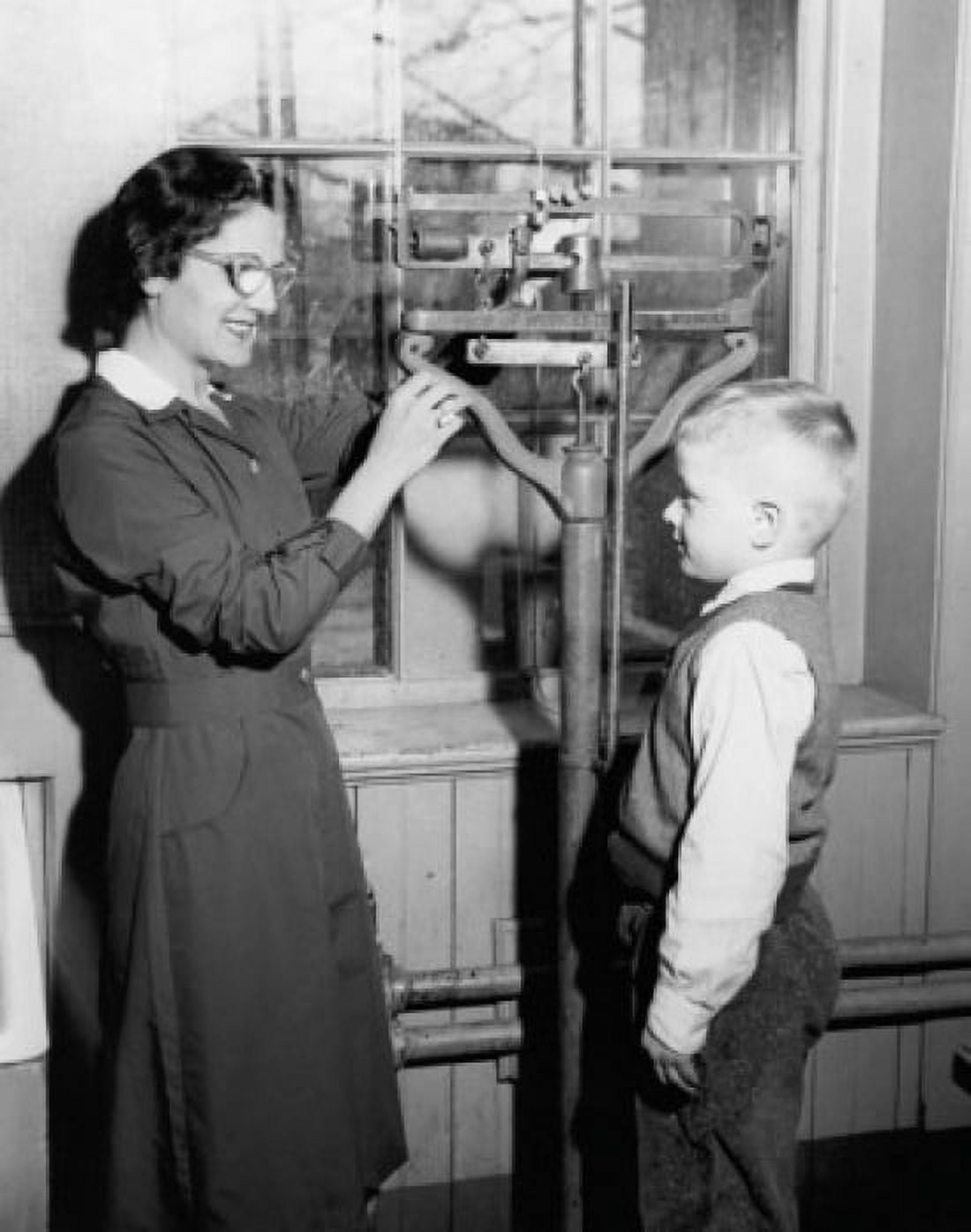 Side profile of a female pediatrician weighing a boy Canvas Art - (24 x 36)