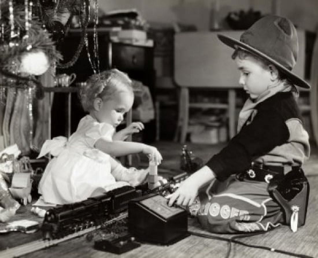 Side profile of a girl and her brother playing with a toy train Canvas Art - (18 x 24)