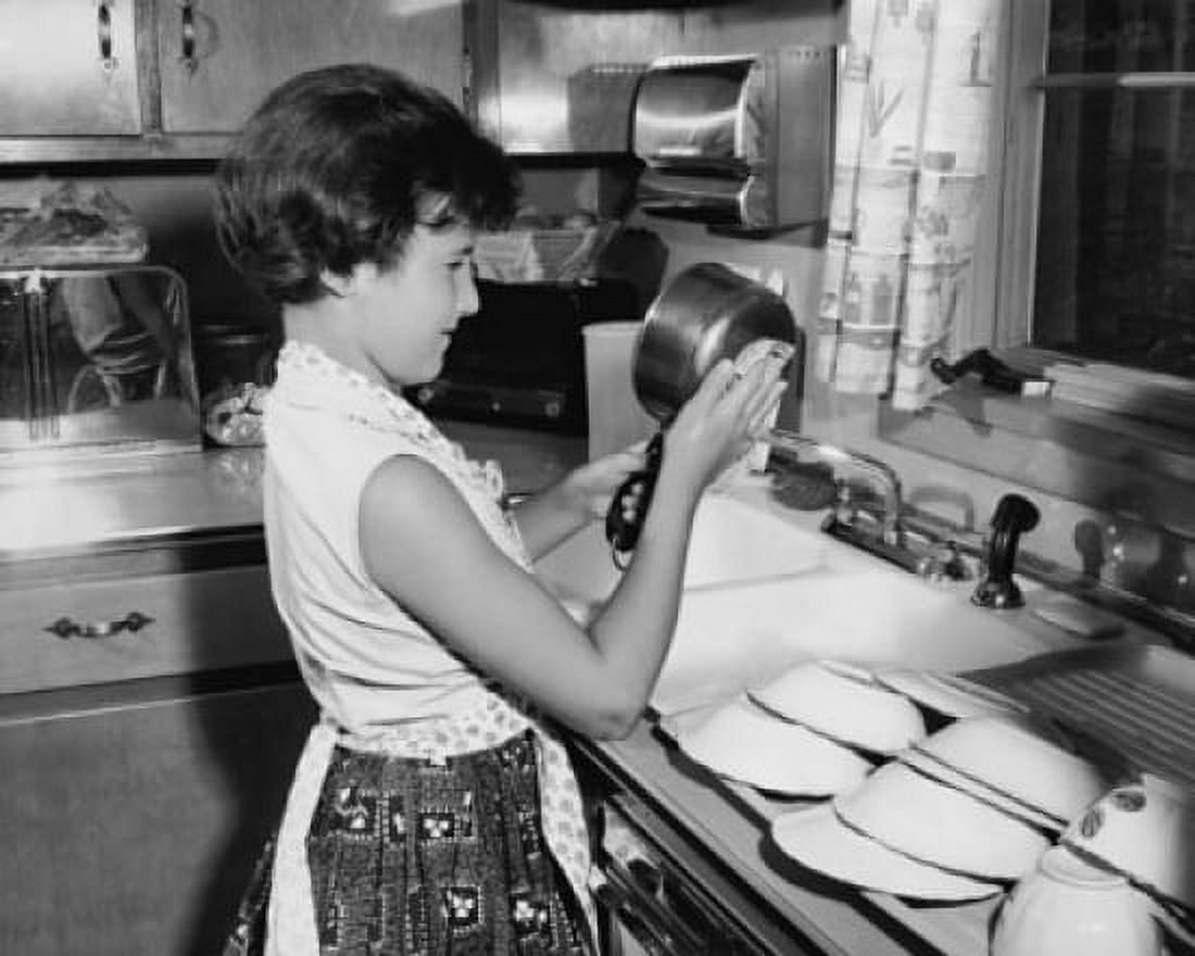 Side profile of a girl cleaning a pan Canvas Art - (24 x 36)