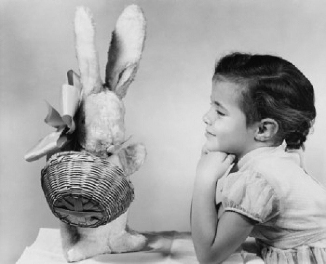Side profile of a girl looking at a stuffed rabbit and smiling Canvas Art - (24 x 36)