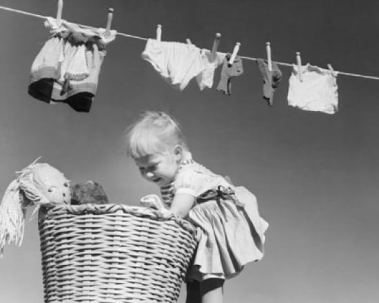 Side profile of a girl looking into a laundry basket Canvas Art - (24 x 36)