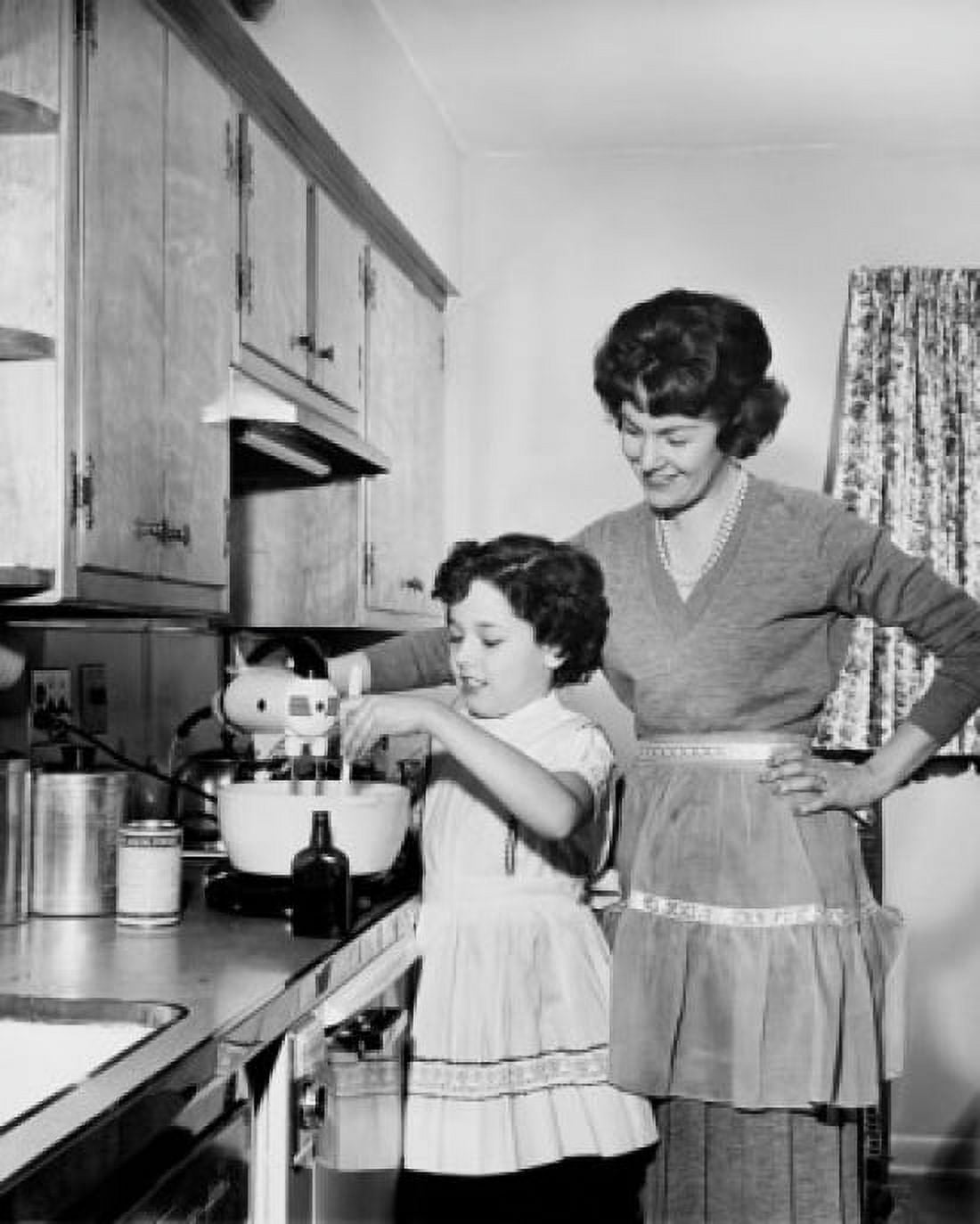 Side profile of a girl preparing food in the kitchen with her mother standing beside her Canvas Art - (18 x 24)