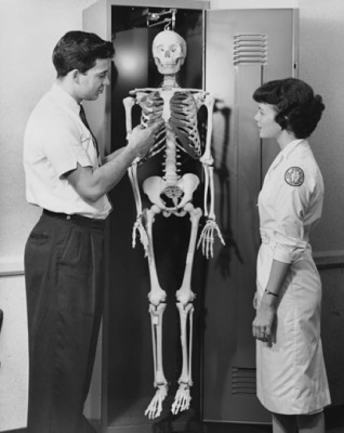 Side profile of a male doctor explaining about human skeleton to a female nurse Canvas Art - (18 x 24)