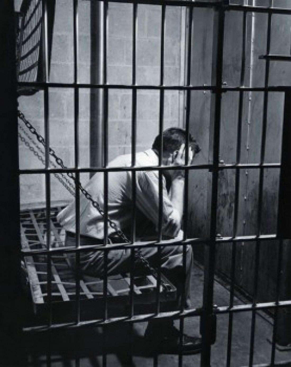 Side profile of a male prisoner sitting in a prison cell Canvas Art - (18 x 24)
