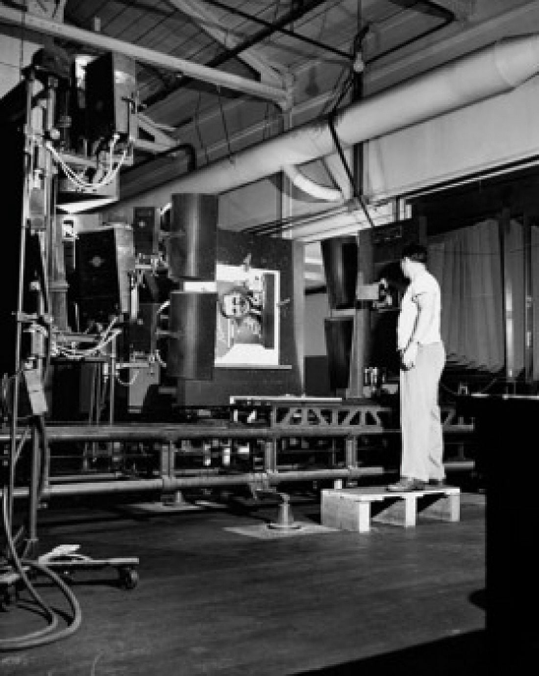 Side profile of a male worker operating a photoengraving camera Canvas Art - (24 x 36)