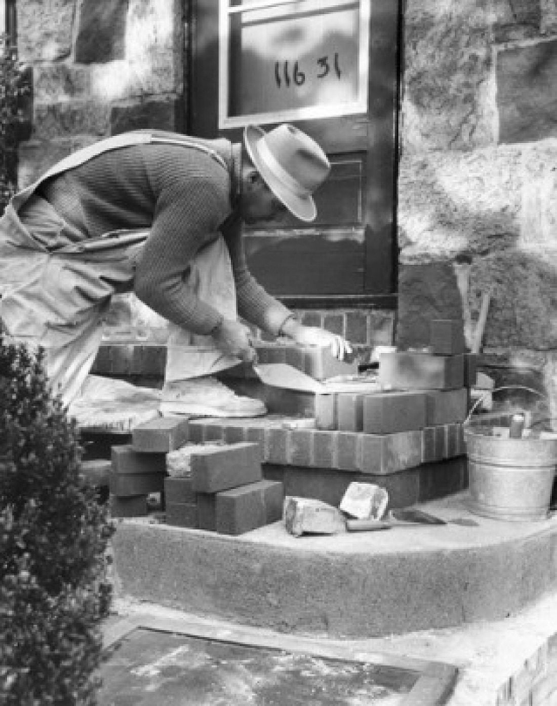 Side profile of a man laying bricks for a doorstep Canvas Art - (24 x 36)