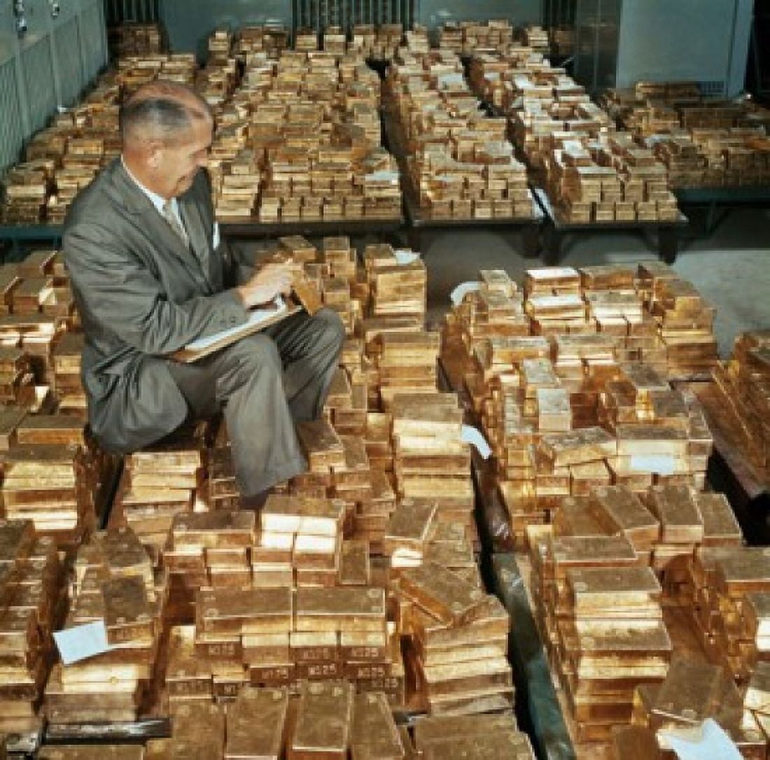 Side profile of a mature man counting gold bars Canvas Art - (18 x 24)