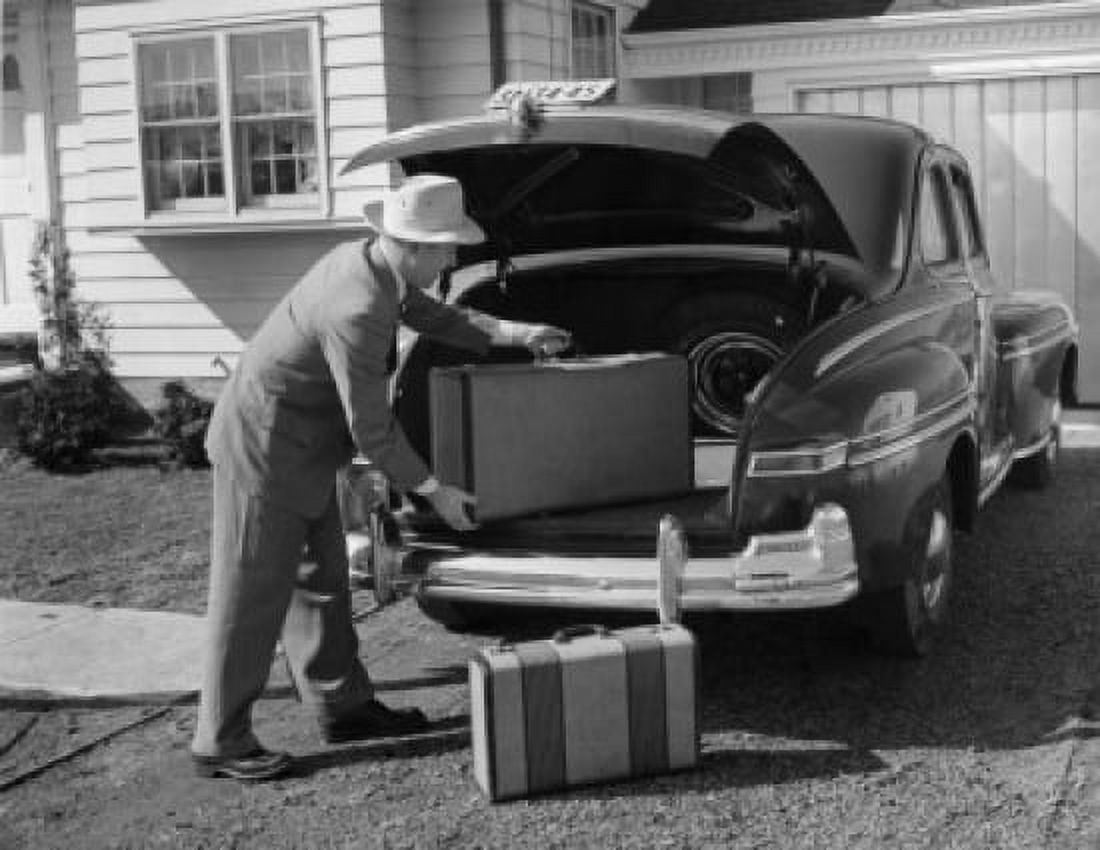 Side profile of a mature man loading a suitcase into the trunk of a car Canvas Art - (18 x 24)