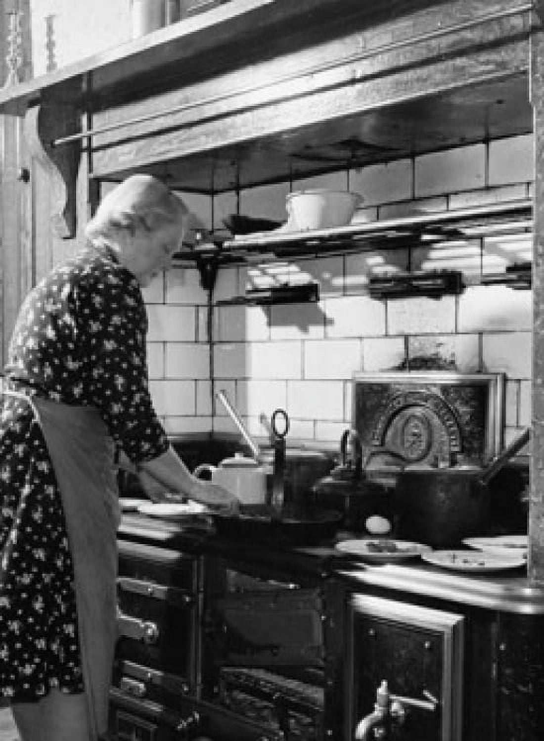Side profile of a mature woman cooking food in the kitchen Canvas Art - (24 x 36)