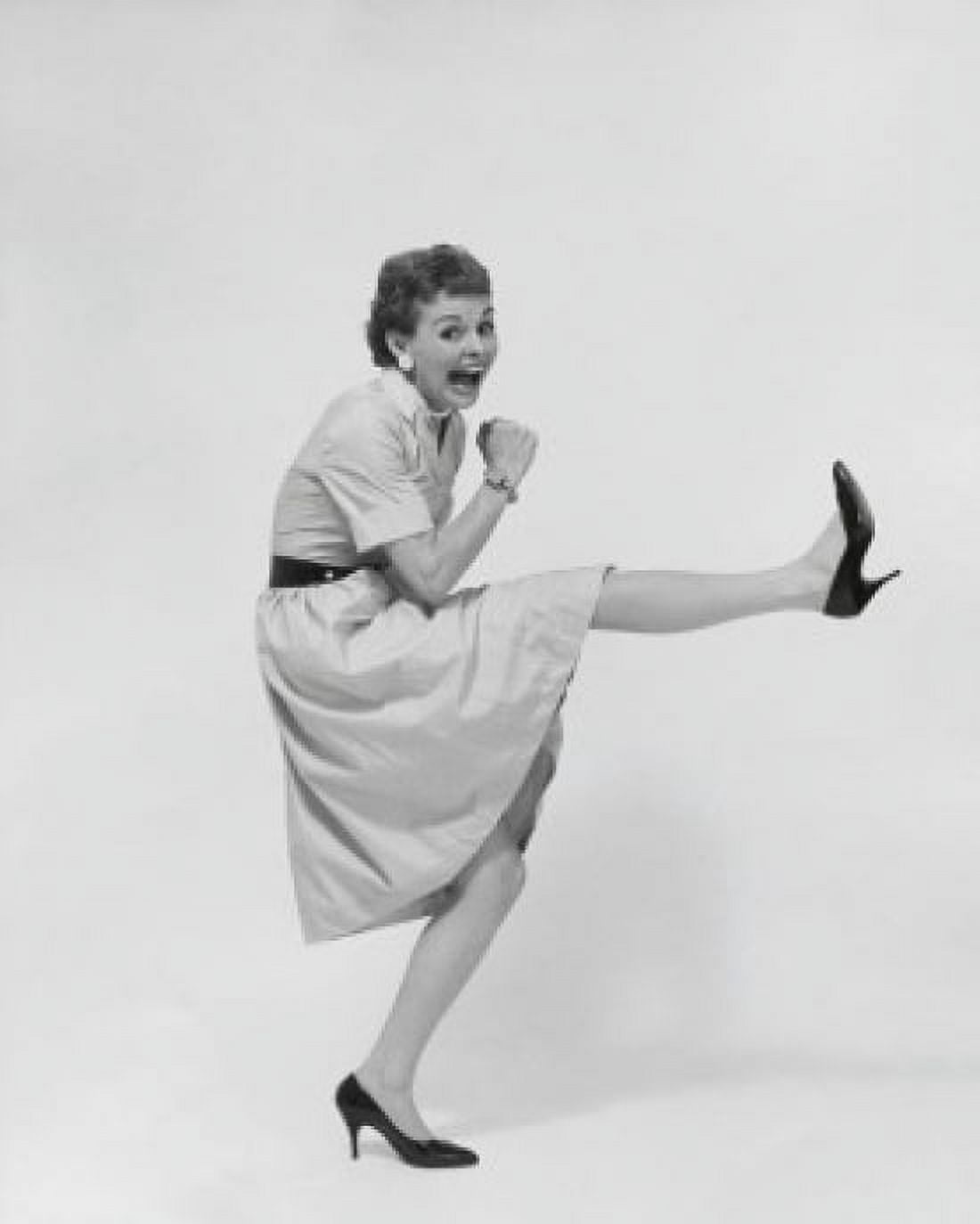 Side profile of a mid adult kicking her leg up Canvas Art - (18 x 24)