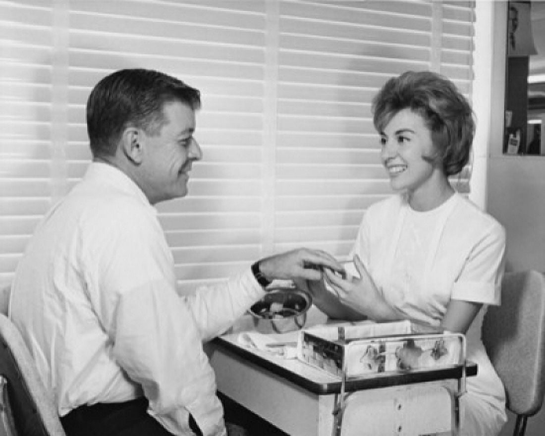 Side profile of a mid adult man receiving a manicure in a nail salon Canvas Art - (24 x 36)