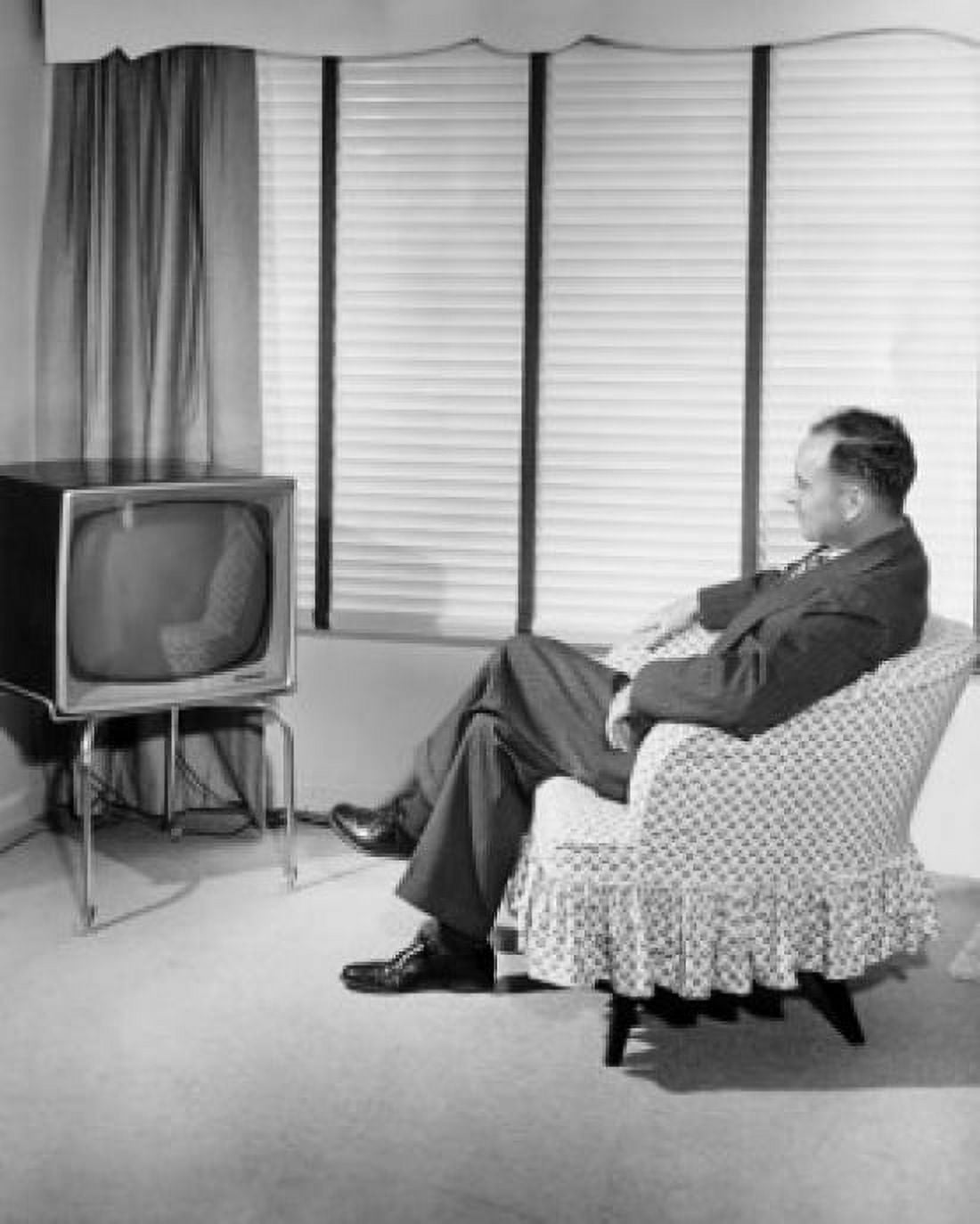 Side profile of a mid adult man sitting in front of a television Canvas Art - (18 x 24)