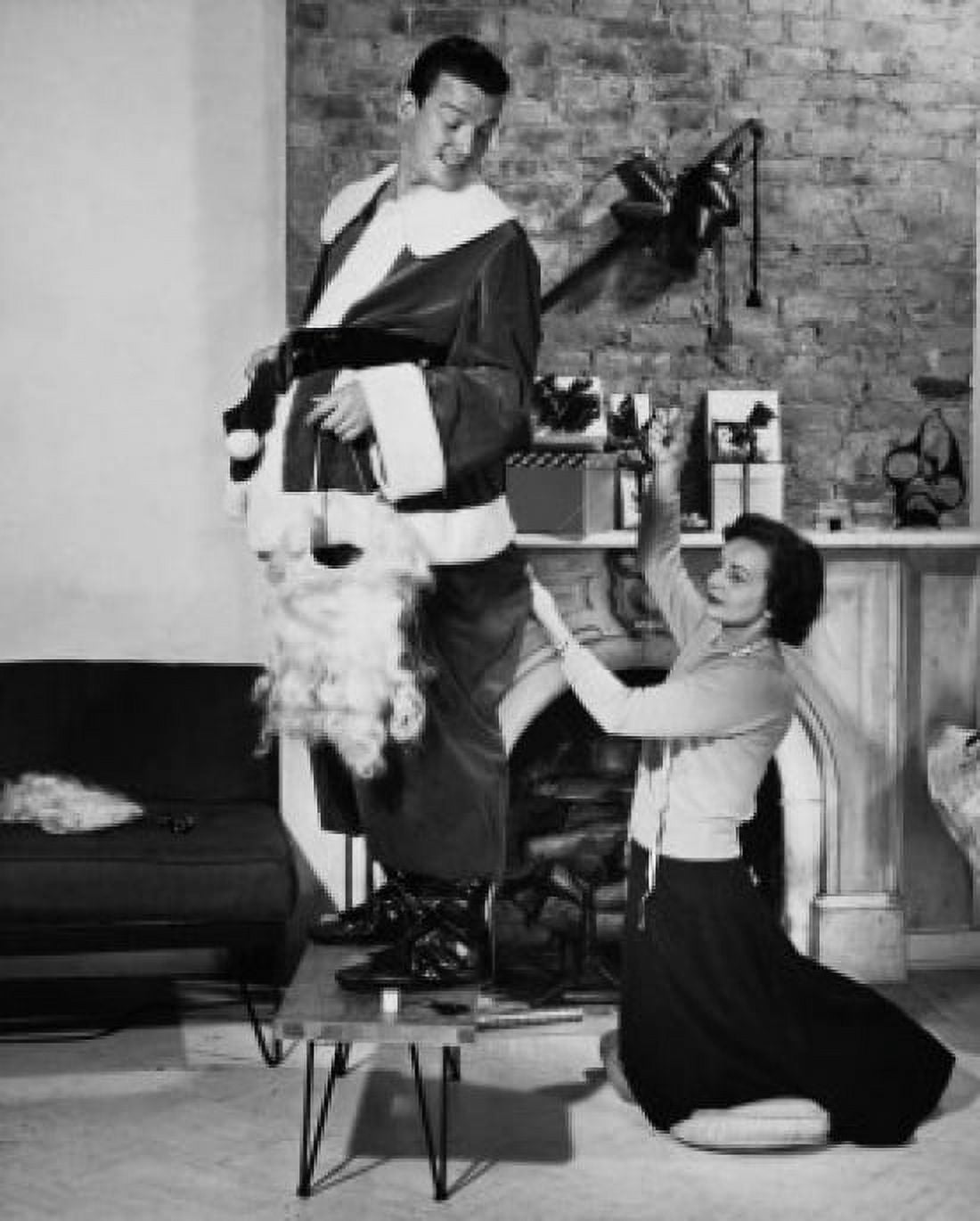 Side profile of a mid adult man standing with a mid adult woman stitching his costume Canvas Art - (24 x 36)