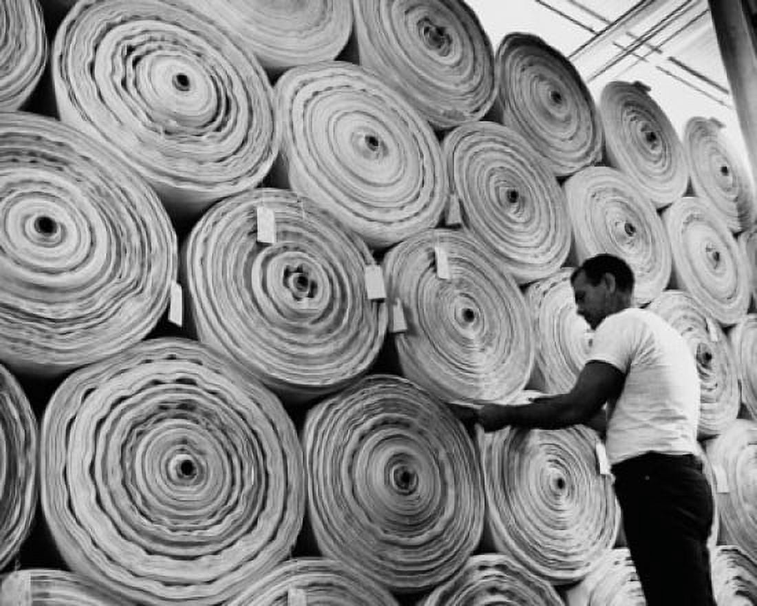 Side profile of a mid adult man tagging rolls of textile Canvas Art - (18 x 24)