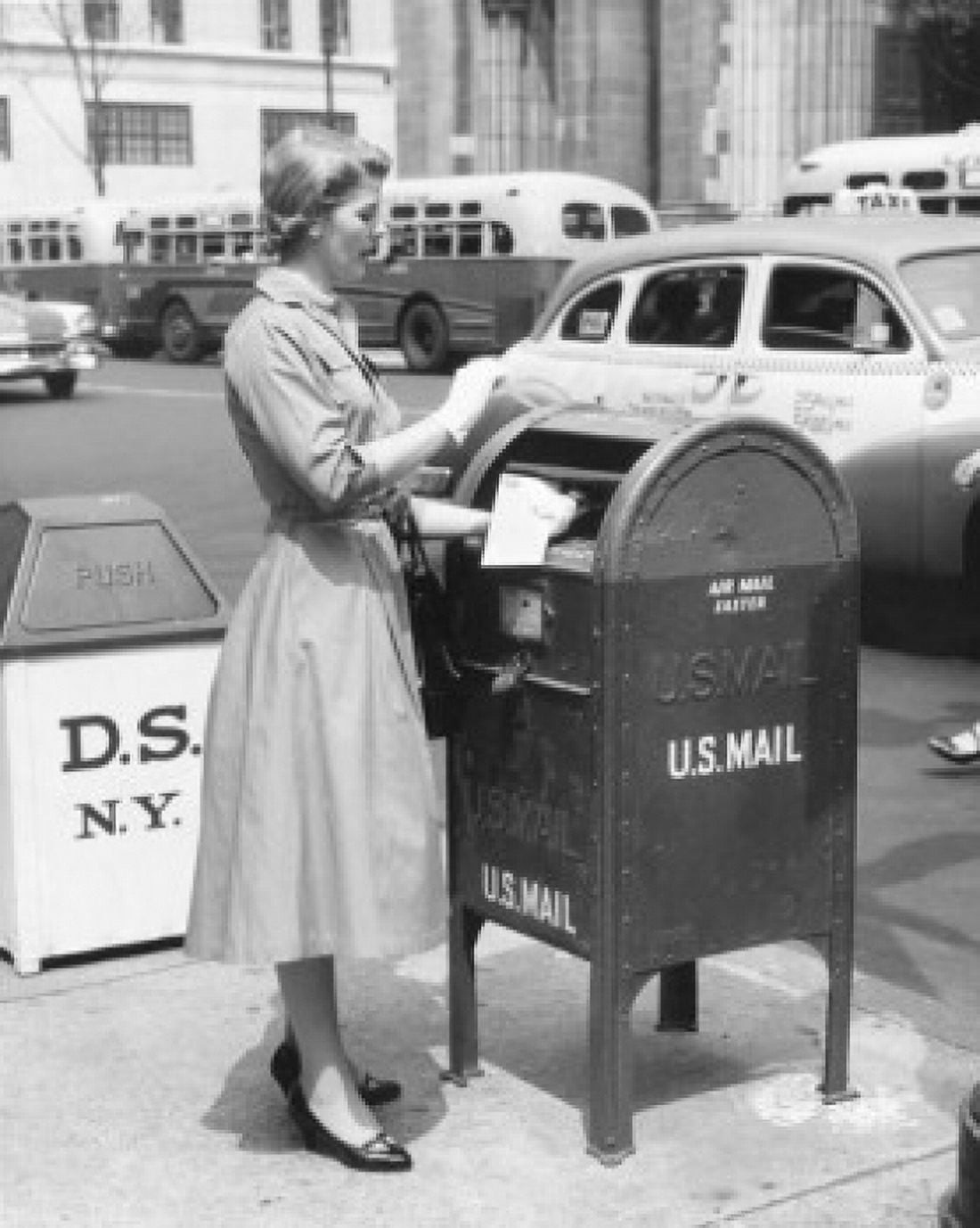 Side profile of a mid adult woman dropping mail in a mailbox Canvas Art - (24 x 36)