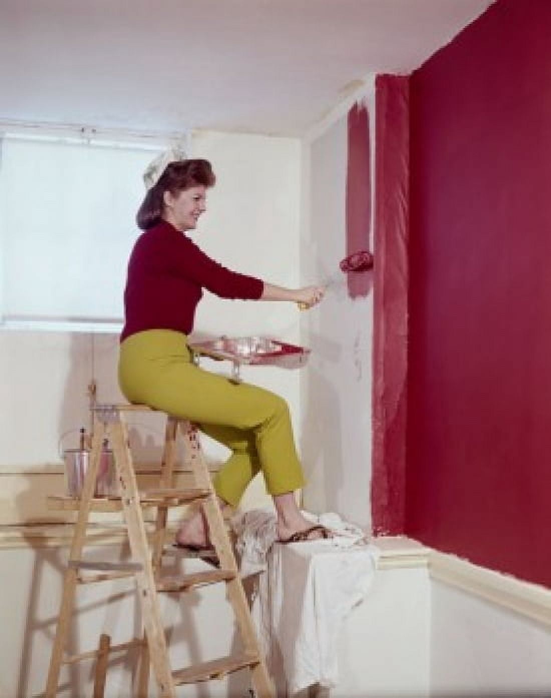 Side profile of a mid adult woman painting a wall with a paint roller Canvas Art - (18 x 24)