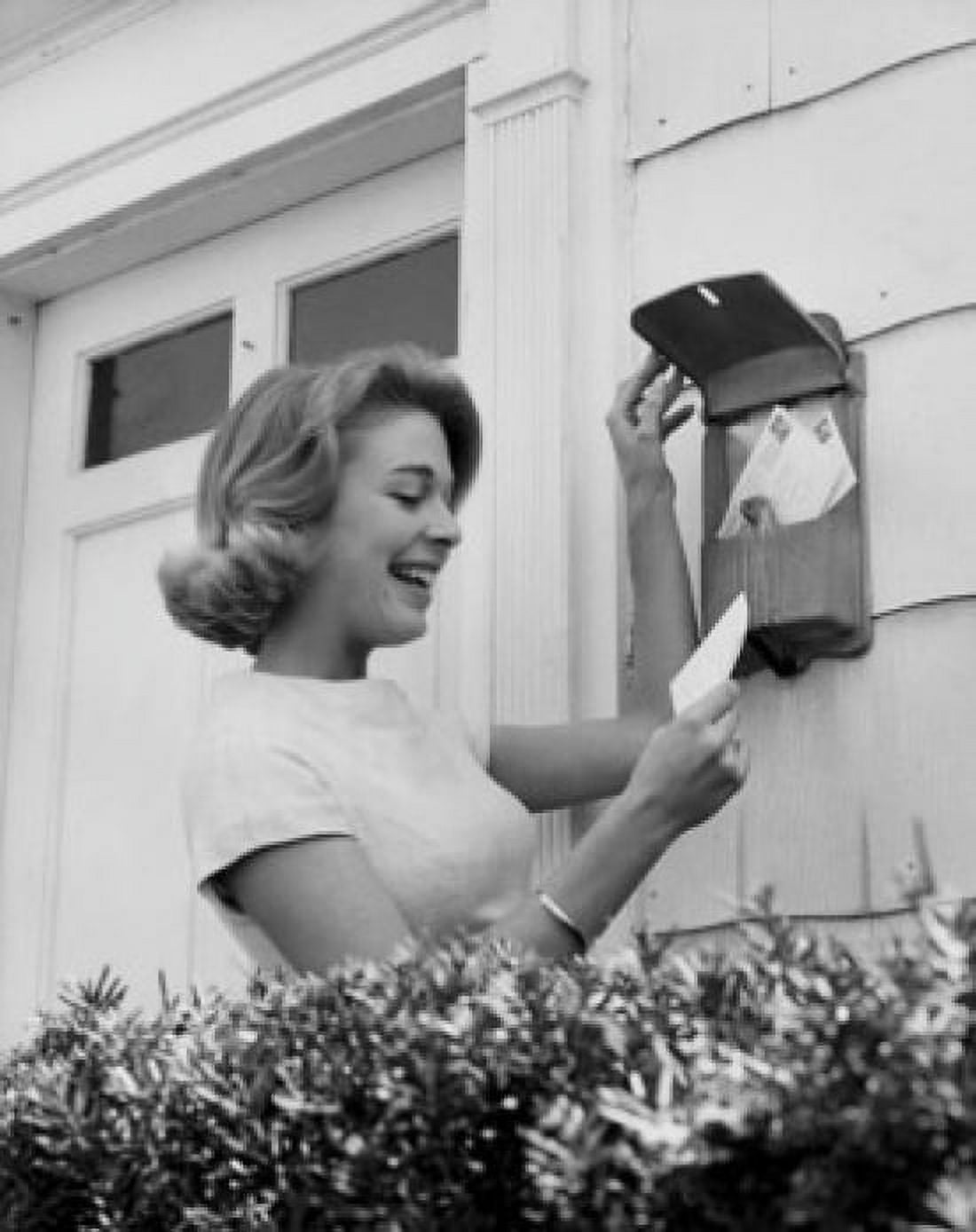 Side profile of a mid adult woman smiling while reading mail Canvas Art - (18 x 24)