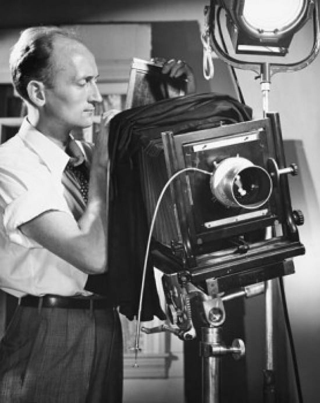 Side profile of a photographer adjusting a camera Canvas Art - (18 x 24)