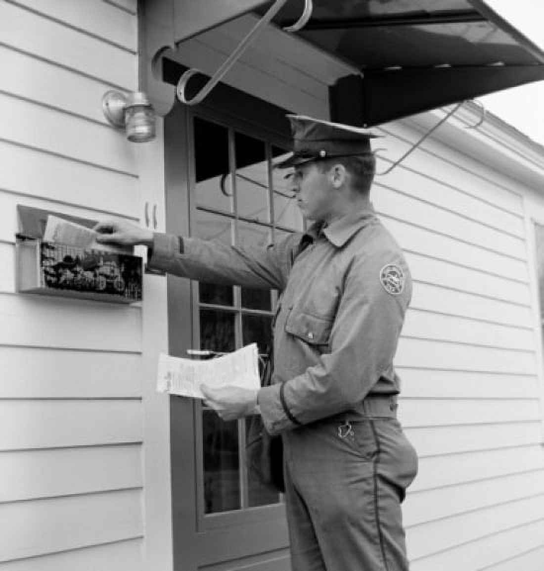 Side profile of a postman dropping mail in a mailbox Canvas Art - (24 x 36)