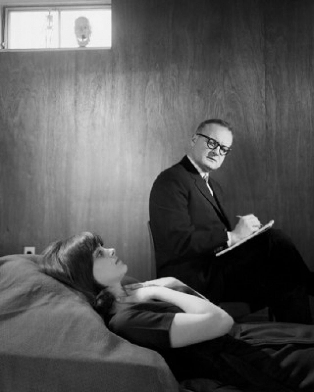 Side profile of a psychologist writing on a note pad after examining a female patient Canvas Art - (24 x 36)