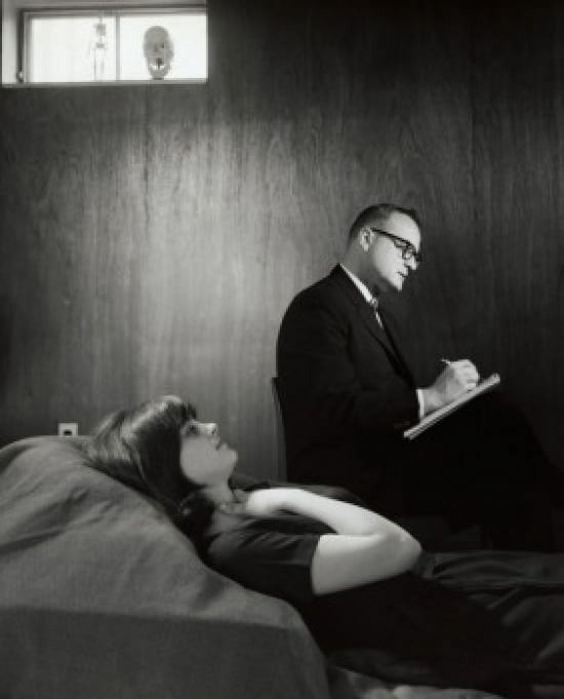 Side profile of a psychologist writing on note pad after examining a female patient Canvas Art - (18 x 24)