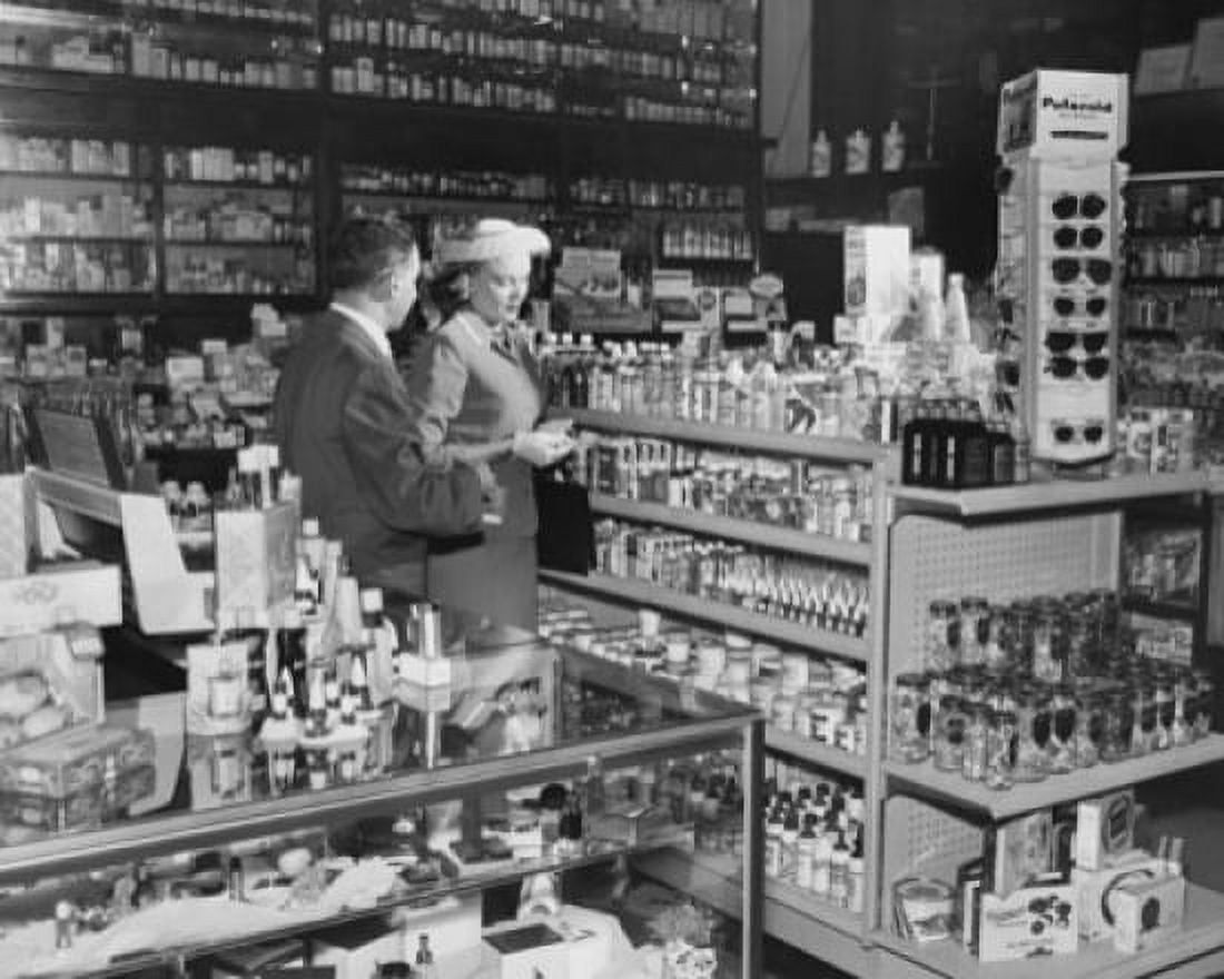 Side profile of a salesman standing with a customer in a store Canvas Art - (24 x 36)