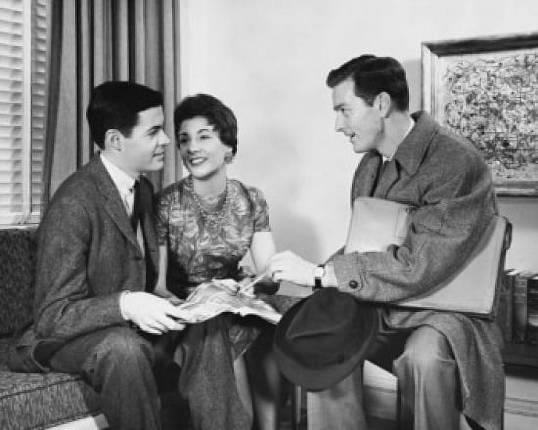 Side profile of a salesman talking to a young couple Canvas Art - (24 x 36)