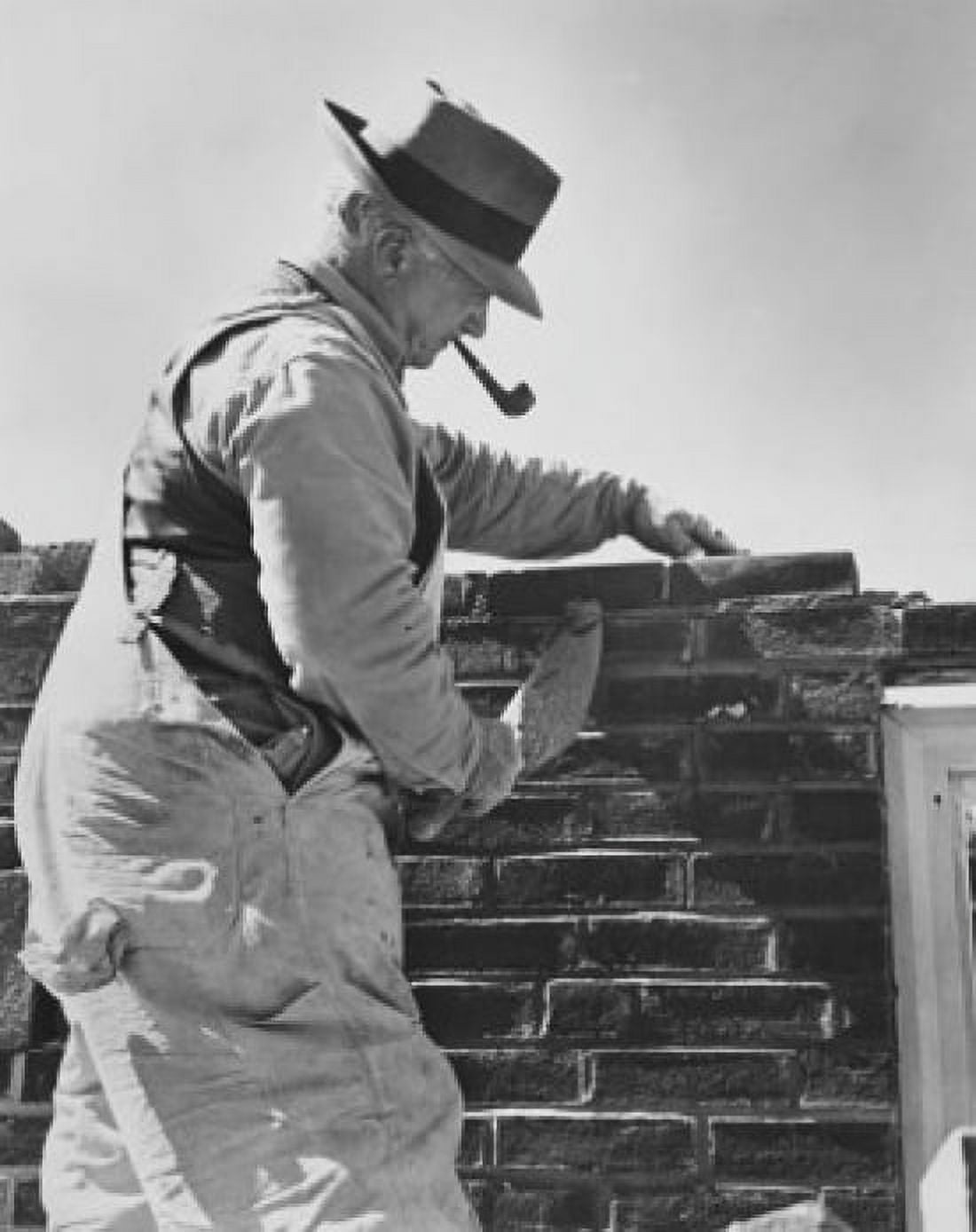Side profile of a senior man laying bricks Canvas Art - (24 x 36)