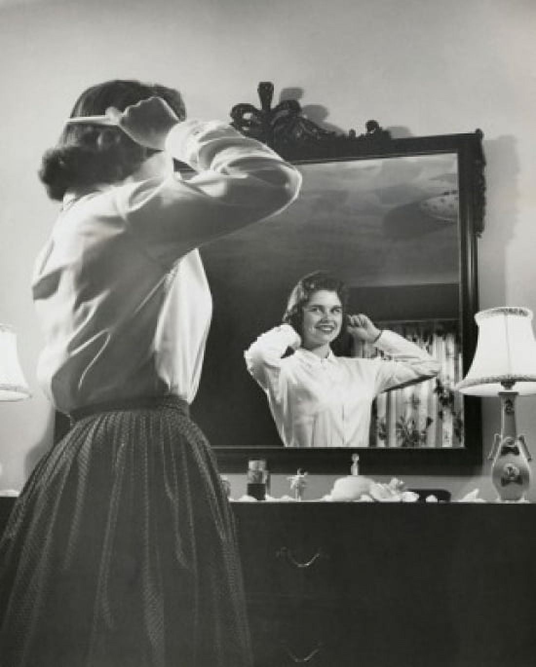 Side profile of a teenage girl combing her hair in front of a mirror Canvas Art - (24 x 36)